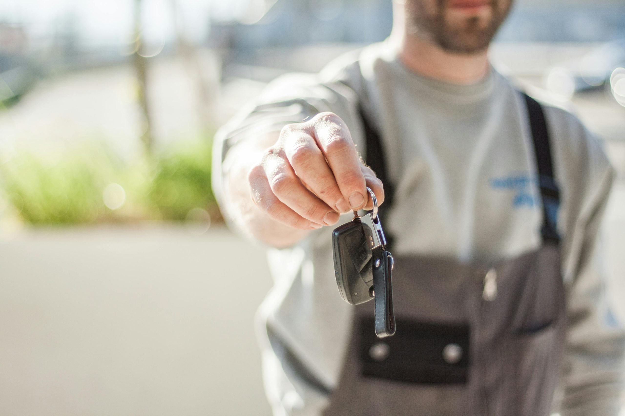 Photo by Negative space car-key-held-by-a-man