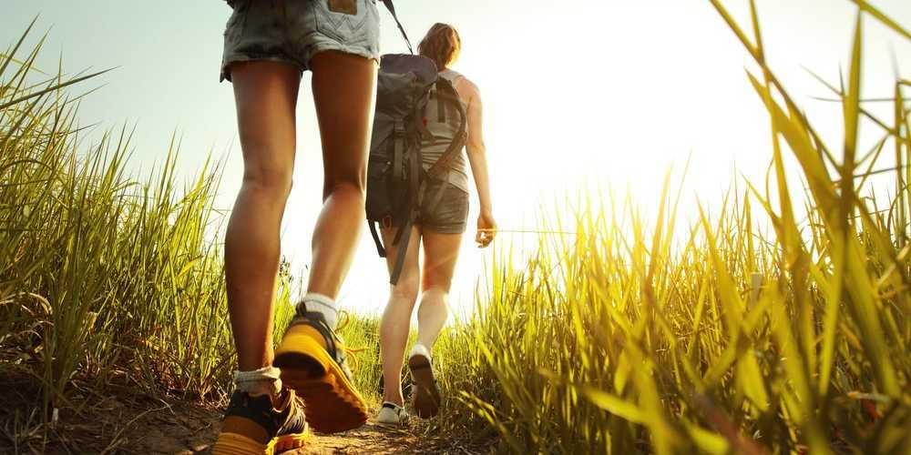 hiking-backpack-through-grass-friends